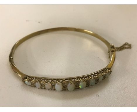 A 9ct opal and diamond bangle