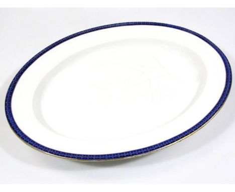 A late 19thC/early 20thC Royal Worcester meat platter, with drainer, sparsely decorated with a blue and gilt line border, mar