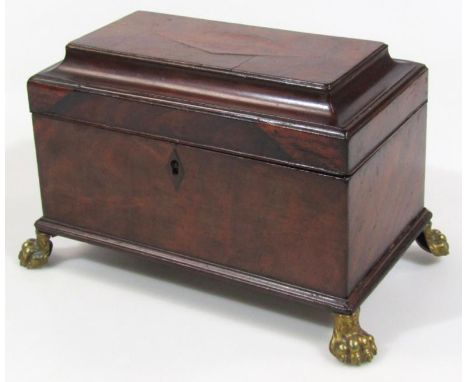 A George III mahogany tea caddy, of rectangular outline, the hinged lid revealing three compartments on heavy hairy paw feet,