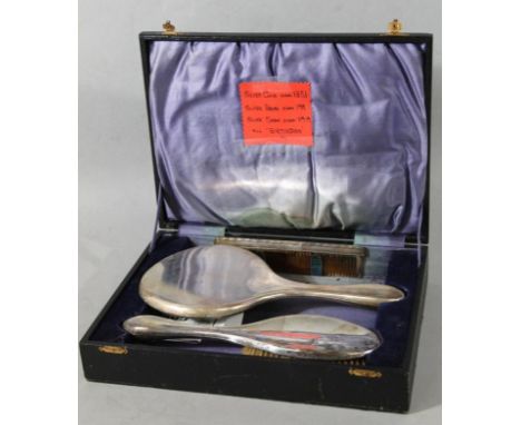 A matched silver dressing table set, comprising mirror, comb and hairbrush, 18cm wide, of plain outline, various marks, in fi