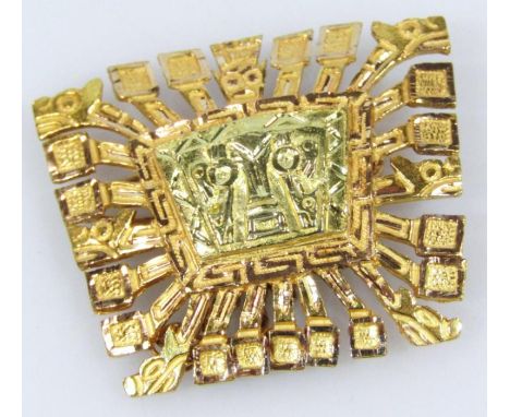 A brooch, in the Inca style with shaped outline and plain pin back, yellow metal, 8.5g, 3cm wide.