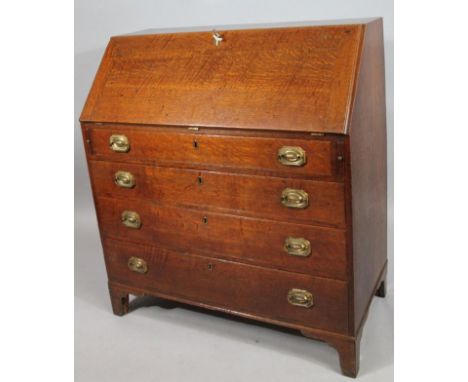 A 18thC oak bureau, the fall front hinging to reveal a fitted interior of drawers and pigeon holes centred by a cupboard abov