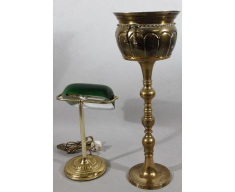 A 1930's style brass desk lamp, with green shade, of modern construction, 43cm high, and a brass jardiniere on turned stand. 