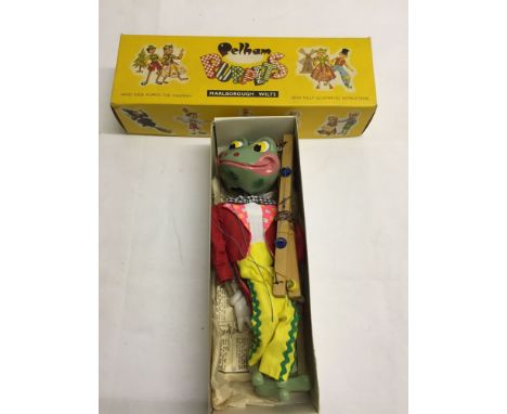 A boxed Pelham Puppet Frog SL9 in excellent condition (box & puppet). Appears unused with instructions.