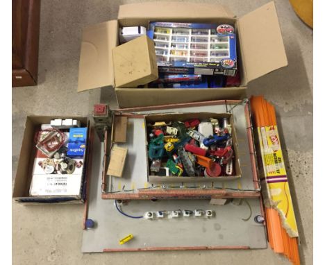 A vintage toy garage with lights, a box of assorted diecast cars and a box for spares/repair.