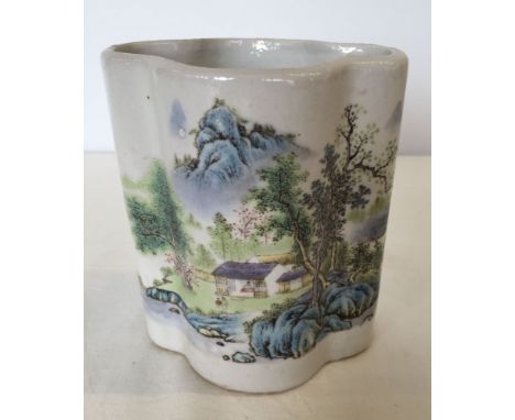 A Chinese ceramic brush pot with landscape scene decoration.