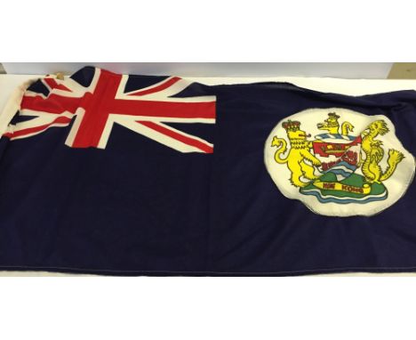 A Hong Kong, blue ensign flag de-commissioned c1999 at the hand-over of Hong Kong to China. 61 x 135cm (2" x 4'5"). Given to 