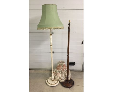 A white and gold standard lamp together with a mahogany standard lamp with round base.