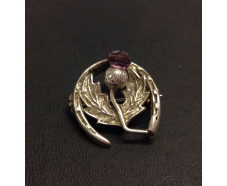 Vintage sterling silver Scottish style brooch with a horseshoe and thistle design set with an amethyst. Measure approx 2cm ac