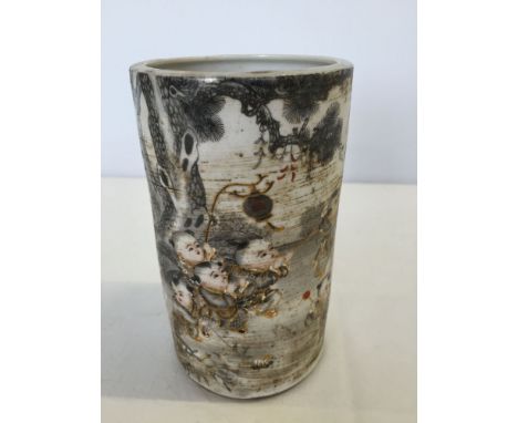 A ceramic Chinese brush pot with children playing painted design (approx 14cm high).