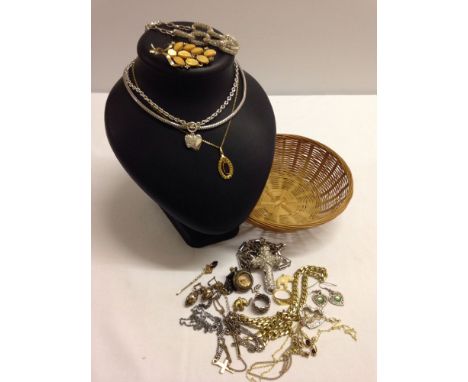 A small basket of vintage and modern costume jewellery.