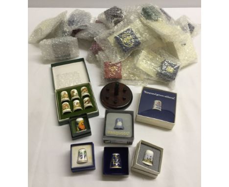 29 Collectors Thimble Club ceramic thimbles including Spode, Limoges, etc. plsu a set of 6 with wooden stand. All in original