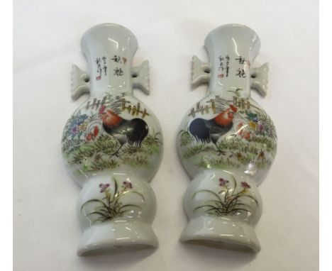 A pair of Chinese ceramic wall pockets with painted cockeral design (approx 19cm high).