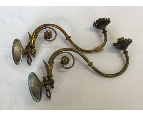 A pair of decorative brass wall light fittings.