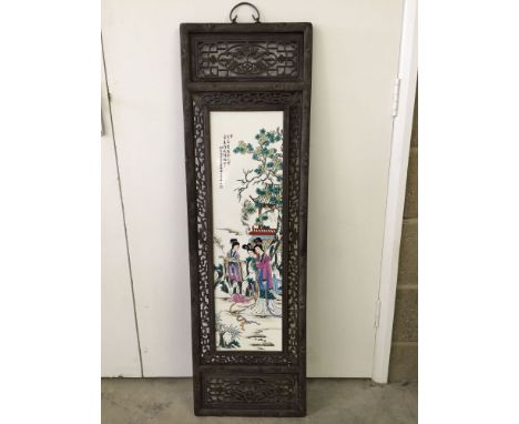 A large ceramic painted Chinese tile set into an ornate wooden casing (approx 36cm wide x 120cm high).