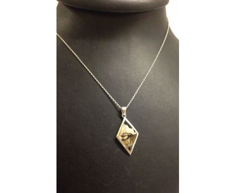 Silver diamond shaped pendant set with mother of pearl/shell.  On an 18" silver chain.