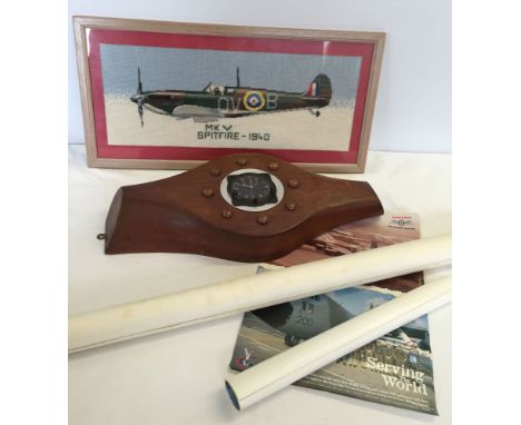 A collection of military items to include a propeller with inset aviation clock, a tapestry of a spitfire and a collection of