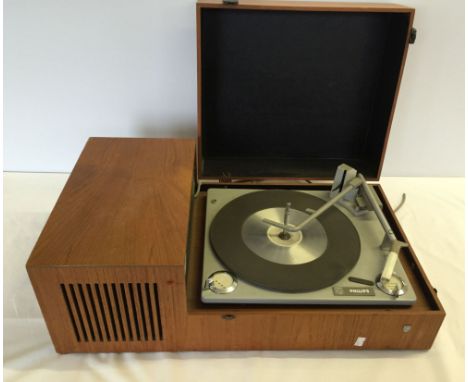 A Philips wooden cased vintage record player with built in speaker.