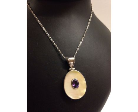 Large oval 925 silver pendant set with mother of pearl and a central oval amethyst.  On a 16" fancy link silver chain.  Total