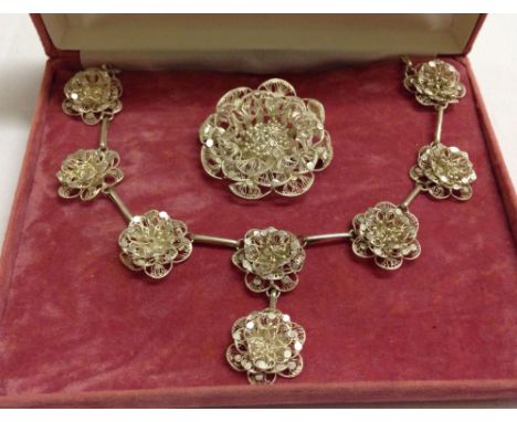 Vintage filigree work necklace and matching brooch in a flower design.