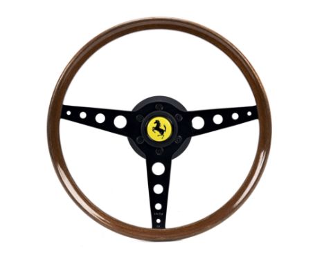 An Indy Ferrari wood-rimmed steering wheel by Momo of Italy,black-painted three-spoke alloy wheel, marked Indy and 'CK' to fr