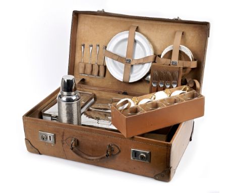 A leather-cased picnic set for four persons, 1920s,tan honey leather case with handle, nickelled locks with catches, the lid 