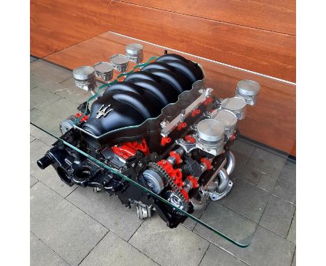 A Maserati Quattroporte 4.2 V8 engine coffee table,the 2005 engine reconditioned, sonically cleaned and presented as a unique