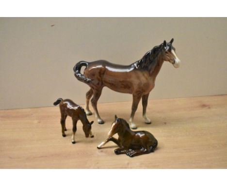 A Beswick Pottery 'Swish Tail Horse' model number 1182 (First Version) by Arthur Gredington in brown gloss finish sold togeth