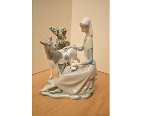 A Lladro porcelain figure group, 'Girl Shepherdess' model number 4570, measures 25cm.