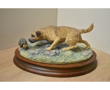 A Border Fine Arts figure group 'Border Terrier (With Hedgehog)' model number 066 by David Geenty, on wooden plinth complete 