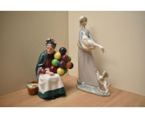 A Royal Doulton bone china figurine 'The Old Balloon Seller' HN 1315 sold together with a Lladro porcelain figure group 'Girl