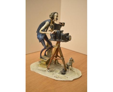 A continental porcelain study of a photographer or film maker having damage to his right arm and coat, bearing signature to b