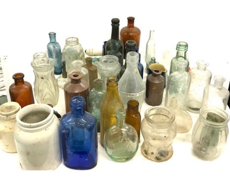 Large selection of vintage medicine and advertising glass bottles 