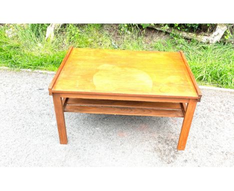 1960s teak coffee table with magazine shelf under neath measures approx 16" tall 31" wide 23" depth 