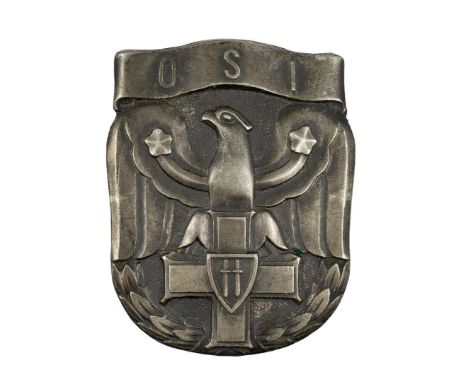One-piece badge made of white metal, oxidized. A badge in the shape of a shield shield with a stylized eagle leaning its talo