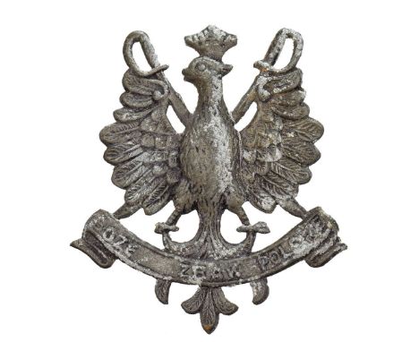 Badge from the First World War in the form of a Polish crowned eagle with spread wings, behind it a pair of crossed sabers. U