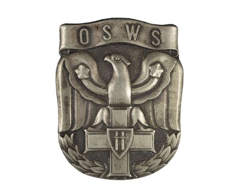 One-piece badge made of white metal, oxidized. A badge in the shape of a shield shield with a stylized eagle leaning its talo