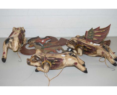 THREE HANGING INDONESIAN WOODEN FLYING PIGS PLUS A FURTHER CUT OUT SHADOW PUPPET