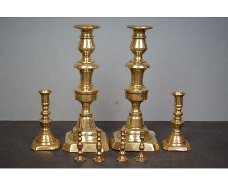 A pair of brass 19th century candlesticks together with a quantity of brass taper stick holders. 