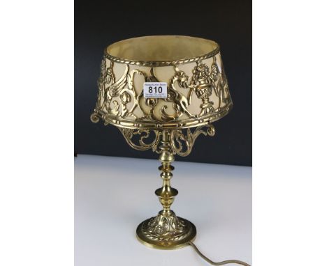 An ornate brass table lamp with pierced brass shade. 