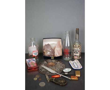 A box of mixed collectables to include a vintage penknife, medals, quartz crystals and advertising milk bottles. 