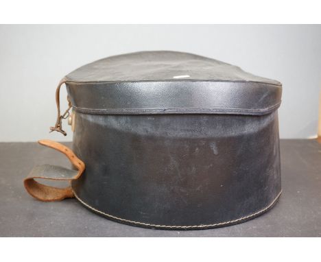 A vintage black leather hatbox. 