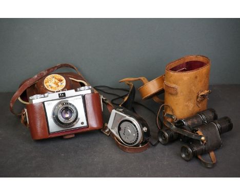 A vintage Zeiss Ikon Contina 35mm camera together with a light meter and a pair of cased binoculars. 