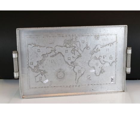 A vintage aluminium serving tray decorated with a map of the world. 