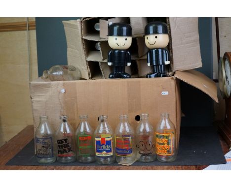 A collection of vintage advertising milk bottles together with a Fred Homepride flour shaker.