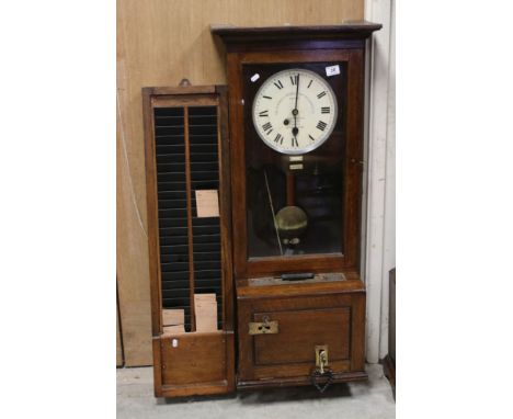 An early 20th century oak cased Gledhill Brook Time Recorder clocking in clock together with a wall oak card holder. 