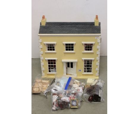 A large vintage Dolls house complete with a good quantity of furniture. 