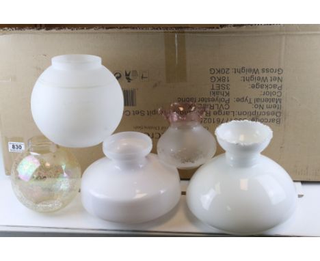 A collection of fourteen glass oil lamp shades. 