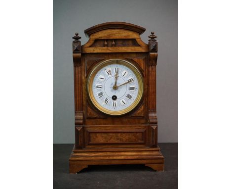 A wooden cased mantle clock with blue enamel dial, single train movement 