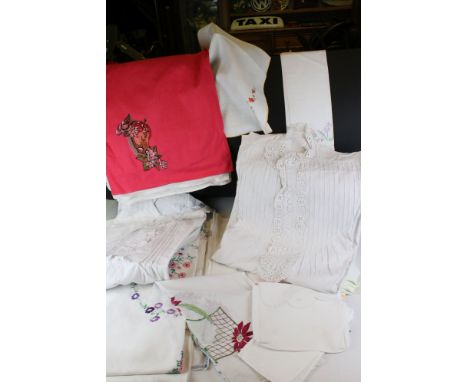 A collection of vintage linen to include napkins, tea towels and tables cloths. 